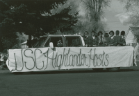 Thumbnail for 'Highlander Hosts participate in a Homecoming parade, early 1990s.'