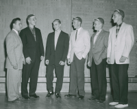 Thumbnail for 'Five WSC freshmen in their beanies pose for a photograph in the Student Union ballroom, circa late 1950s.'