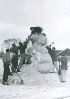 Thumbnail for 'A group of WSC men put the final touches on their Winter Carnival snow sculpture south of the Campus Clubhouse, ca. mid-1950s.'