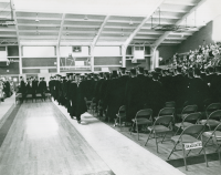 Thumbnail for 'Candidates file in to Mountaineer Gymnasium for Commencement exercises, circa mid-1960s.'