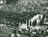 Thumbnail for 'A large WSC graduating class receives their diplomas in Mountaineer Gymnasium, ca. mid-1960s.'