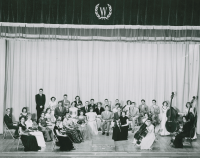Thumbnail for 'An early-1950s WSC orchestra poses for a photograph on stage in Taylor Hall Auditorium.'