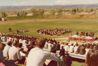 Thumbnail for 'A beautiful Gunnison spring day welcomed commencement exercises at Mountaineer Bowl, ca. 1974.'